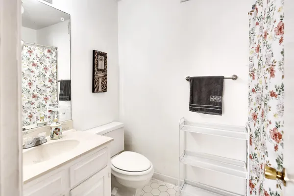 a picture of a bathroom with a refrigerator