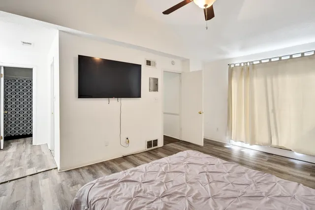 a bedroom with a bed and a flat screen tv
