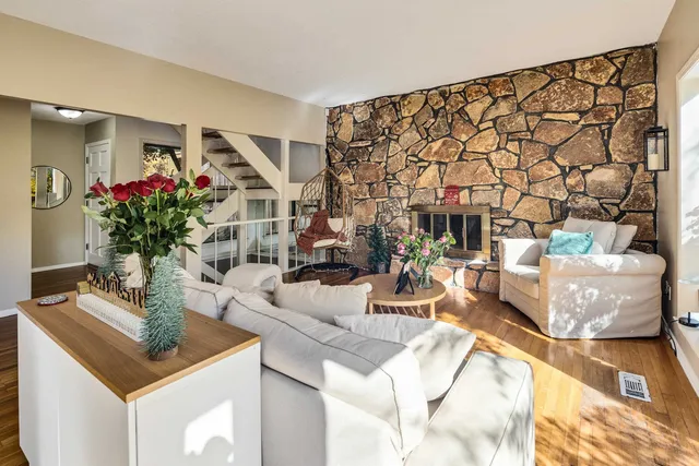 a living room with furniture and flowers