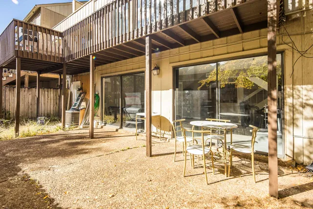 a view of a porch with a table and chairs