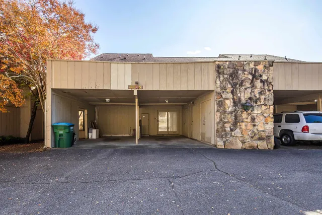 a view of a house with a garage and two chair