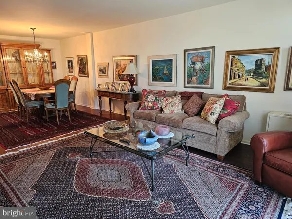 a living room with furniture wooden floor and wall painting