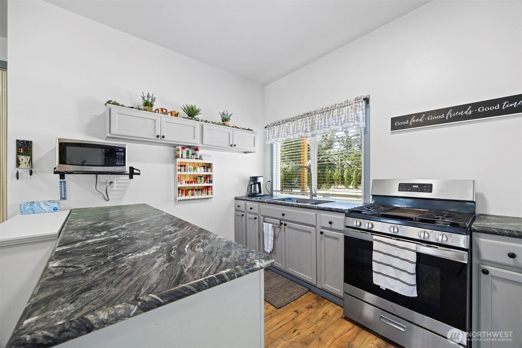 2403 East Hemmi Road Bellingham, WA 98226 - Photo 28 of 40 a kitchen with a stove a sink and a microwave
