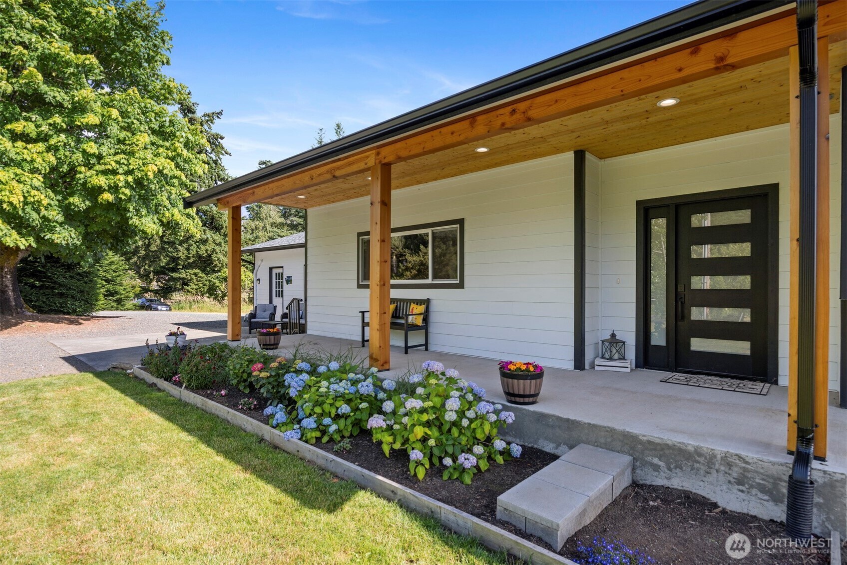 2403 East Hemmi Road Bellingham, WA 98226 - Photo 3 of 40 a front view of a house with garden