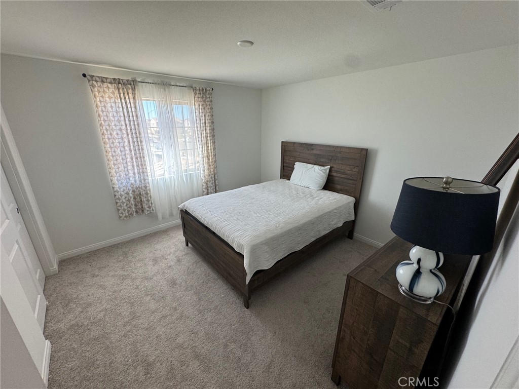 4515 Bandon Avenue Perris, CA 92571 - Photo 16 of 26 a bedroom with a bed and window