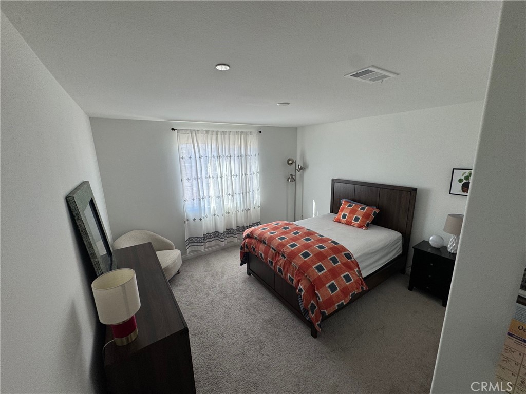 4515 Bandon Avenue Perris, CA 92571 - Photo 17 of 26 a bedroom with a bed chair and window