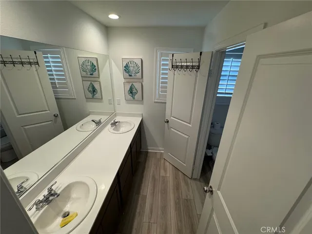a view of bathroom with a sink and mirror
