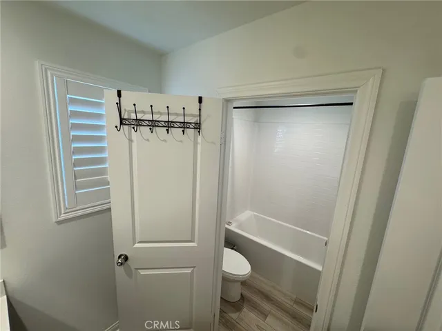 a bathroom with a shower a toilet and a shower