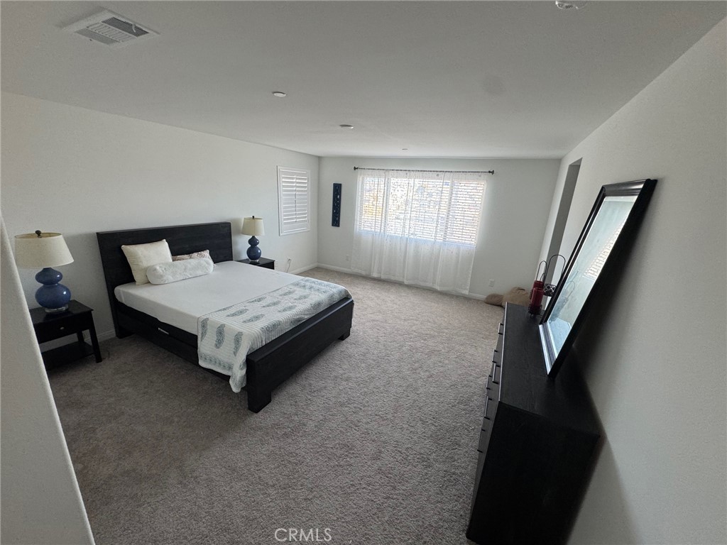 4515 Bandon Avenue Perris, CA 92571 - Photo 20 of 26 a bedroom with a bed and a window