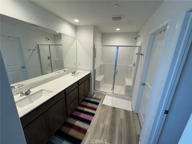 a bathroom with a double vanity sink and mirror