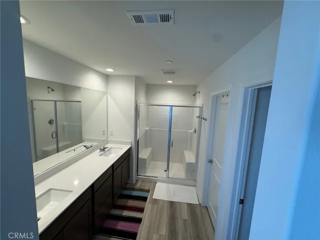 a bathroom with double vanity and mirrors