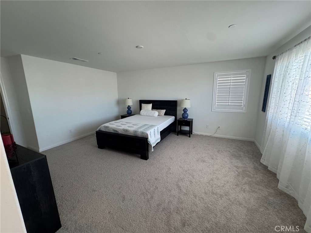 4515 Bandon Avenue Perris, CA 92571 - Photo 24 of 26 a bedroom with a bed and a window