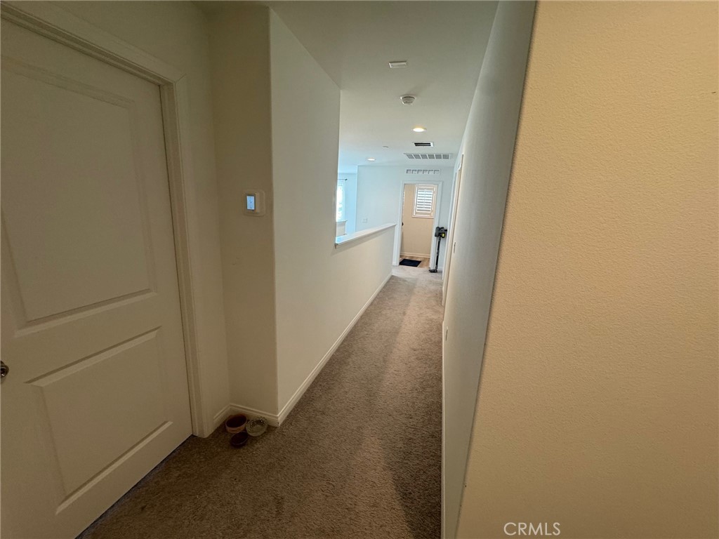 4515 Bandon Avenue Perris, CA 92571 - Photo 25 of 26 a view of a hallway with wooden floor