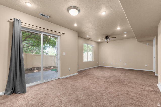3053 Sage Loop, Unit B1 Lehi, UT 84043 - Photo 20 of 25 Spacious room with plush brown carpeting and neutral wall paint