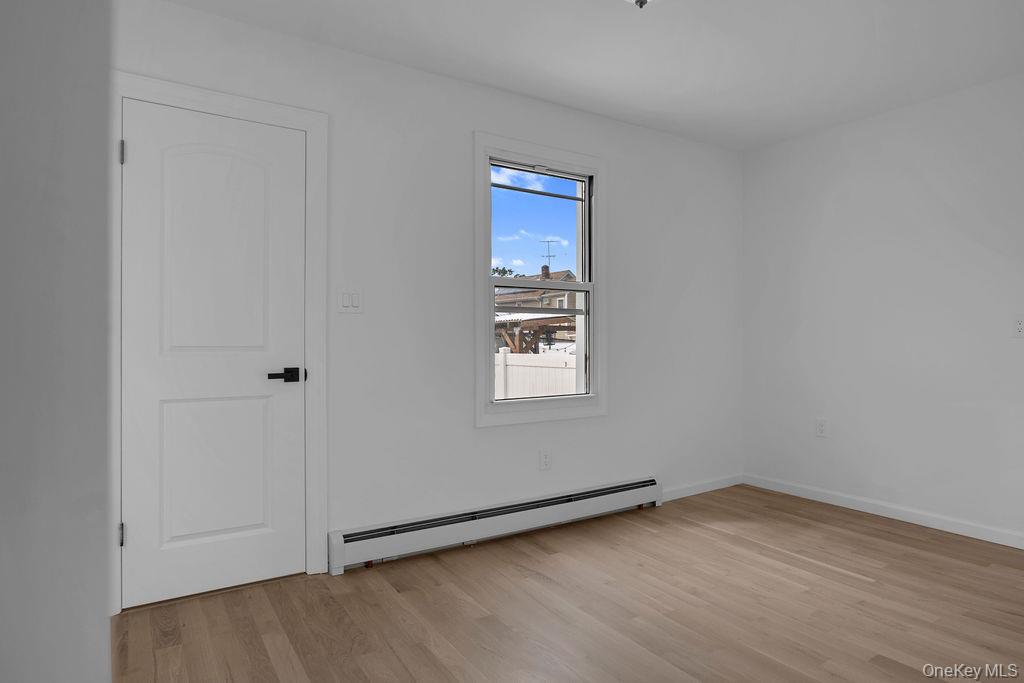 173-62 103rd Road Queens, NY 11433 - Photo 14 of 23 a view of a room that has a window in it
