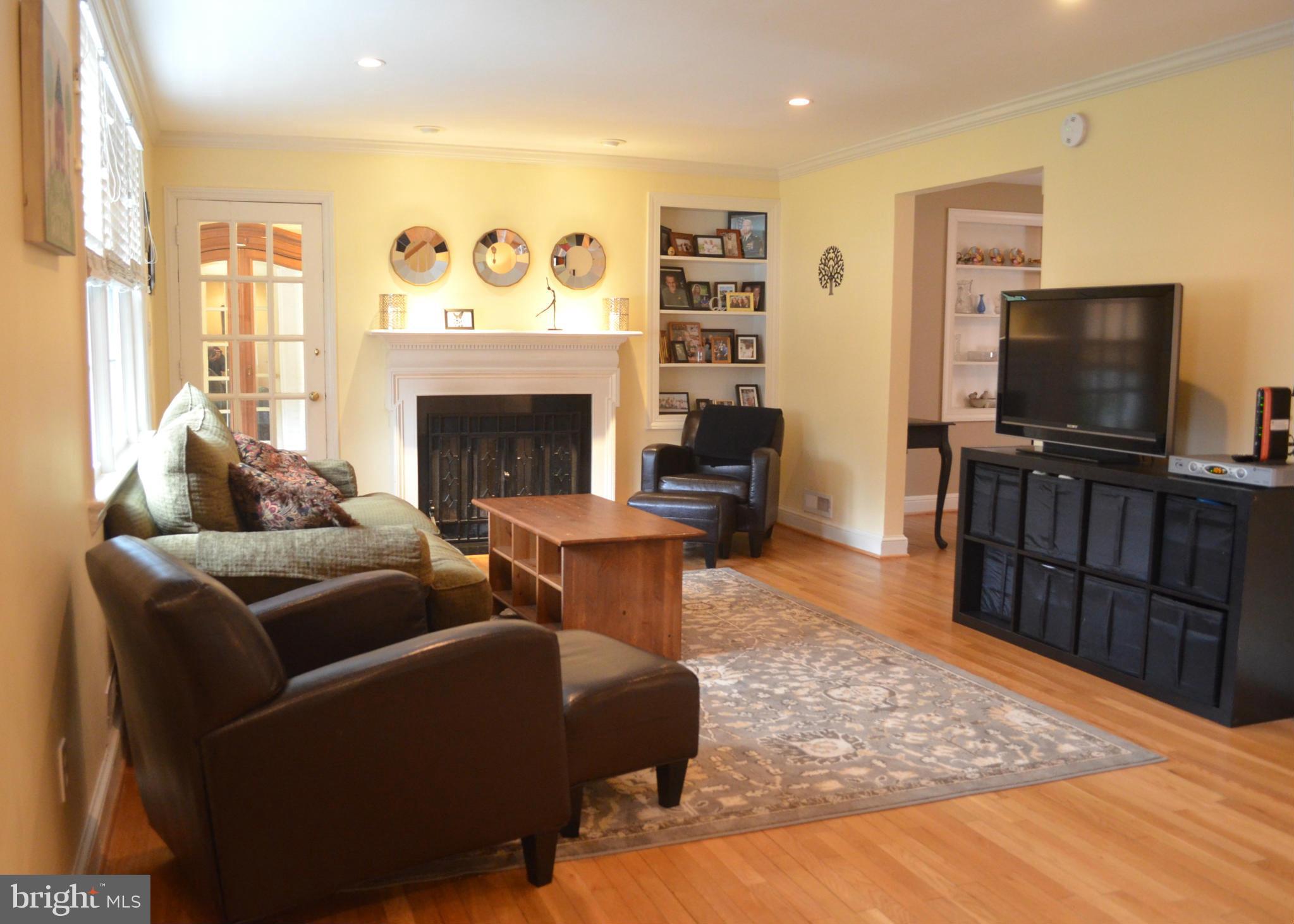 106 Indian Spring Drive Silver Spring, MD 20901 - Photo 11 of 30 a living room with furniture and a flat screen tv