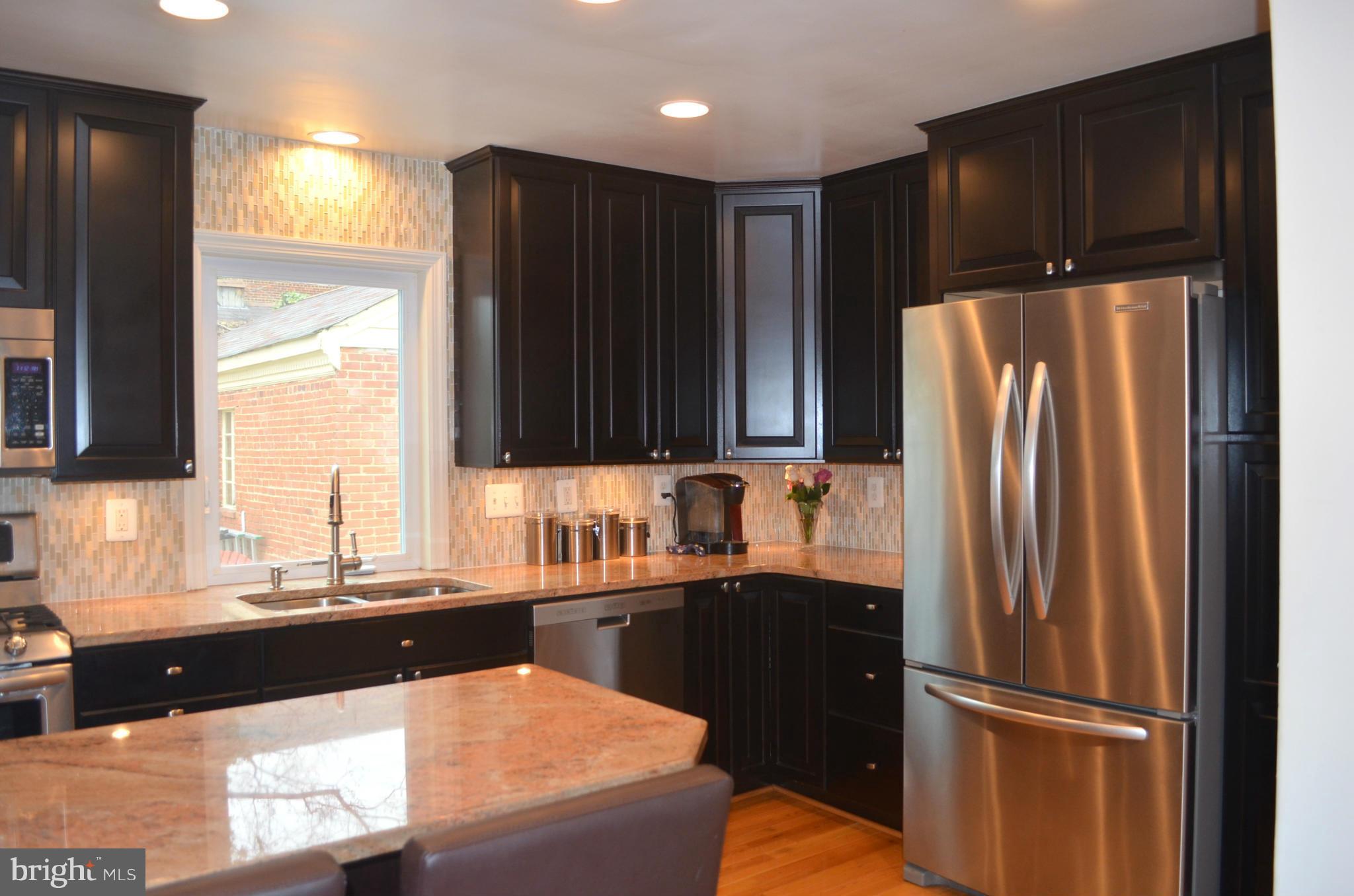 106 Indian Spring Drive Silver Spring, MD 20901 - Photo 16 of 30 a kitchen with stainless steel appliances granite countertop a refrigerator and a sink