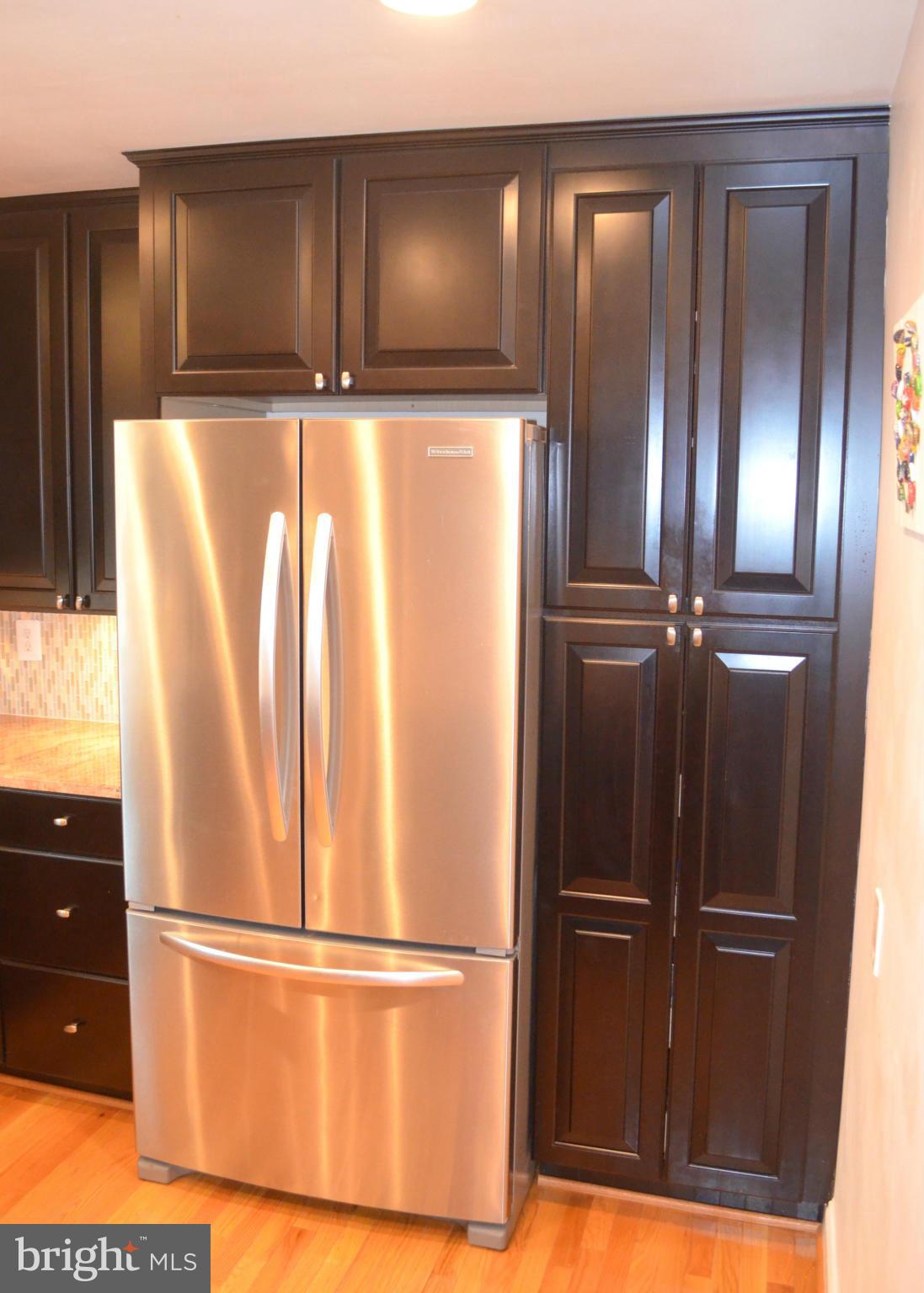 106 Indian Spring Drive Silver Spring, MD 20901 - Photo 18 of 30 a view of a refrigerator in kitchen with stainless steel appliances wooden cabinet and door