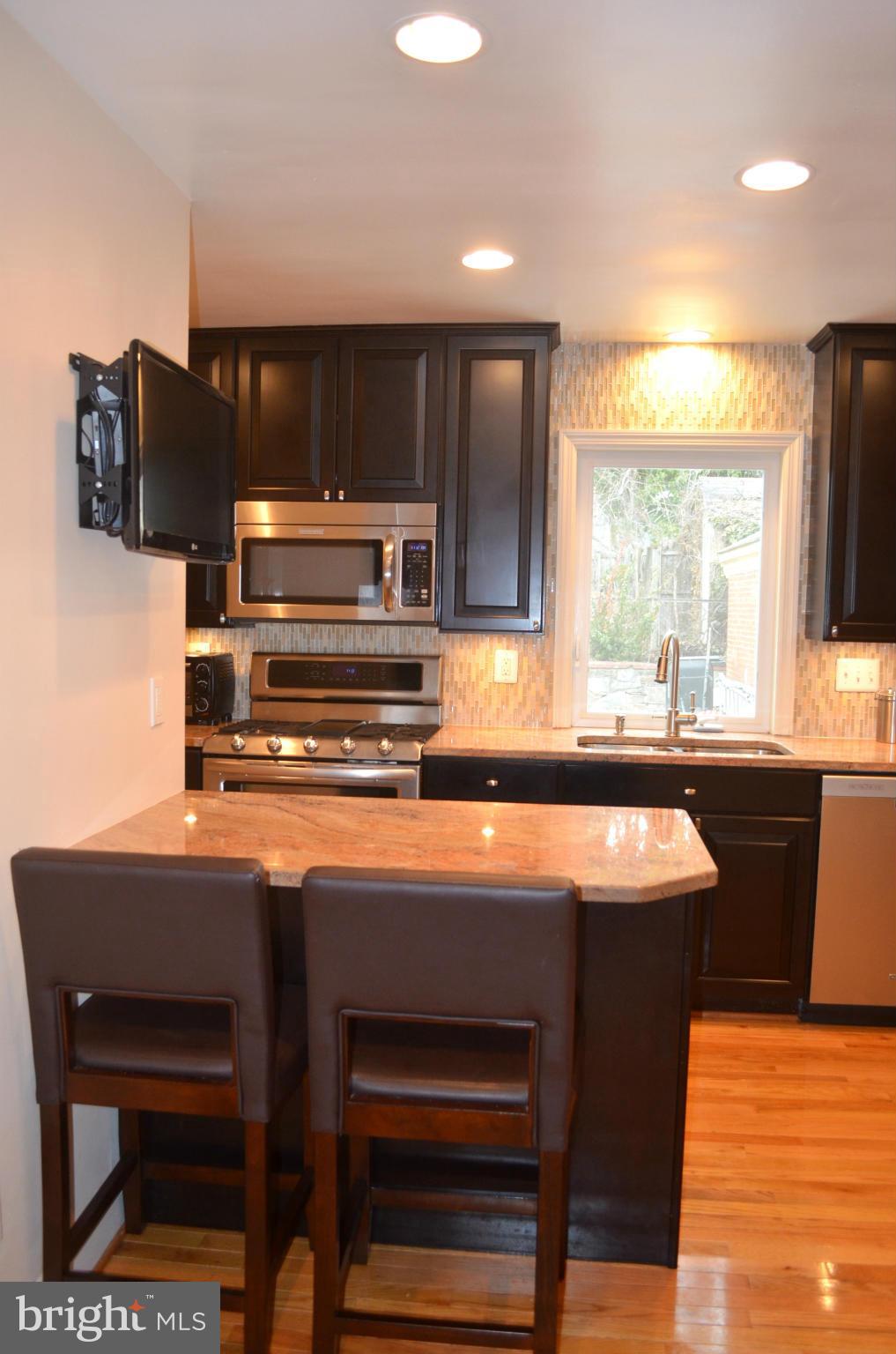 106 Indian Spring Drive Silver Spring, MD 20901 - Photo 20 of 30 a kitchen with stainless steel appliances a stove a sink and a refrigerator