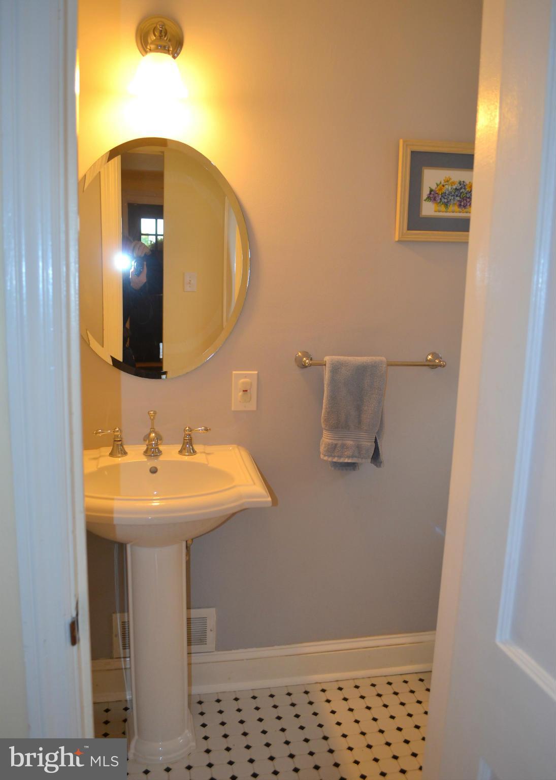 106 Indian Spring Drive Silver Spring, MD 20901 - Photo 21 of 30 a bathroom with a sink and mirror