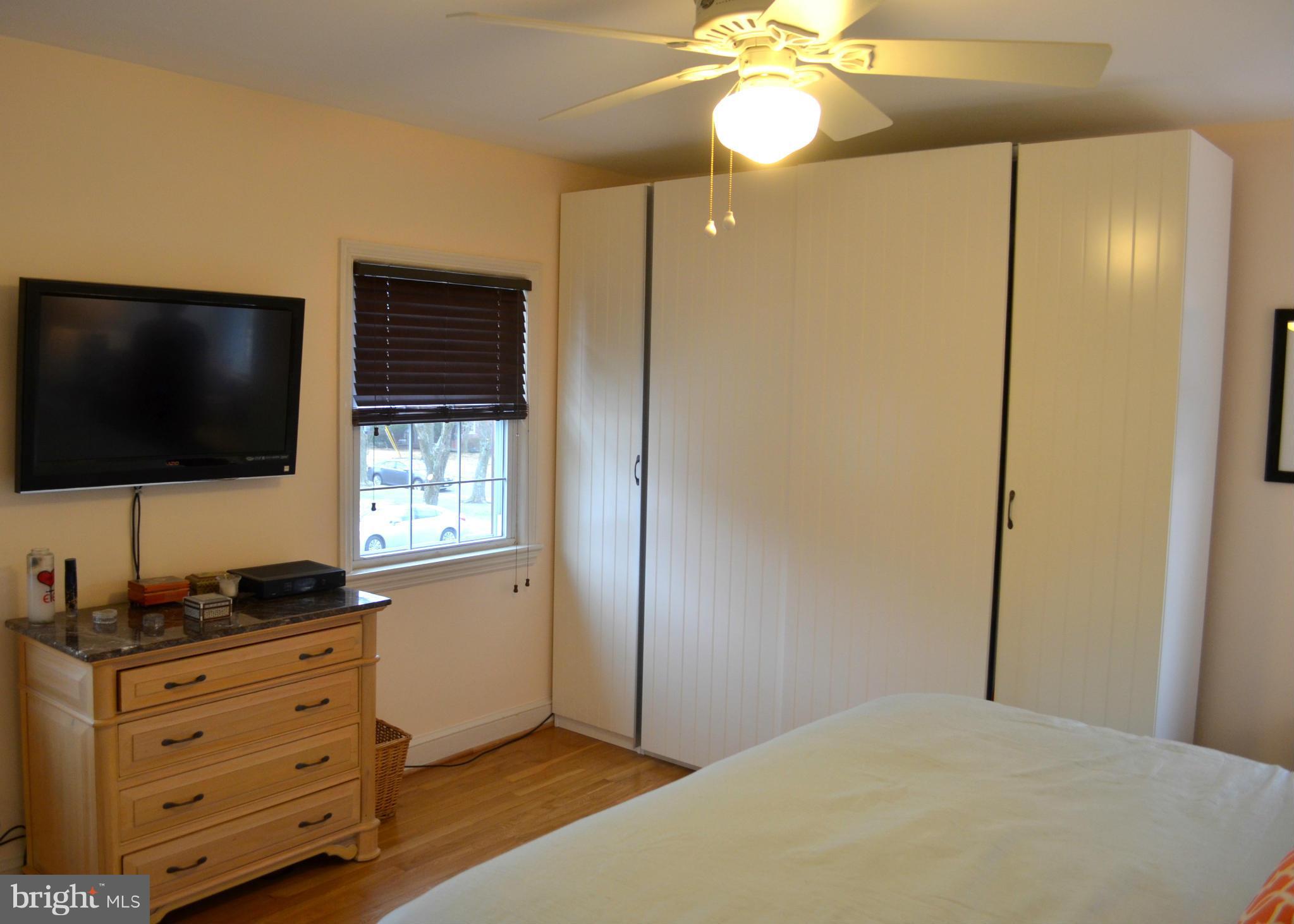106 Indian Spring Drive Silver Spring, MD 20901 - Photo 27 of 30 a bedroom with a bed and a flat screen tv