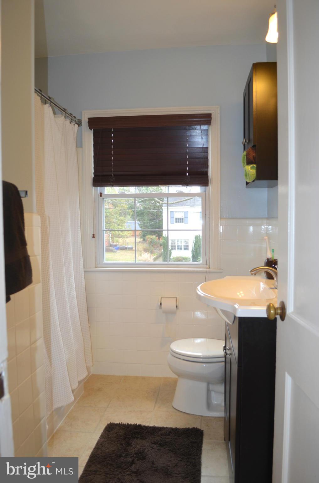 106 Indian Spring Drive Silver Spring, MD 20901 - Photo 28 of 30 a bathroom with a sink and a mirror