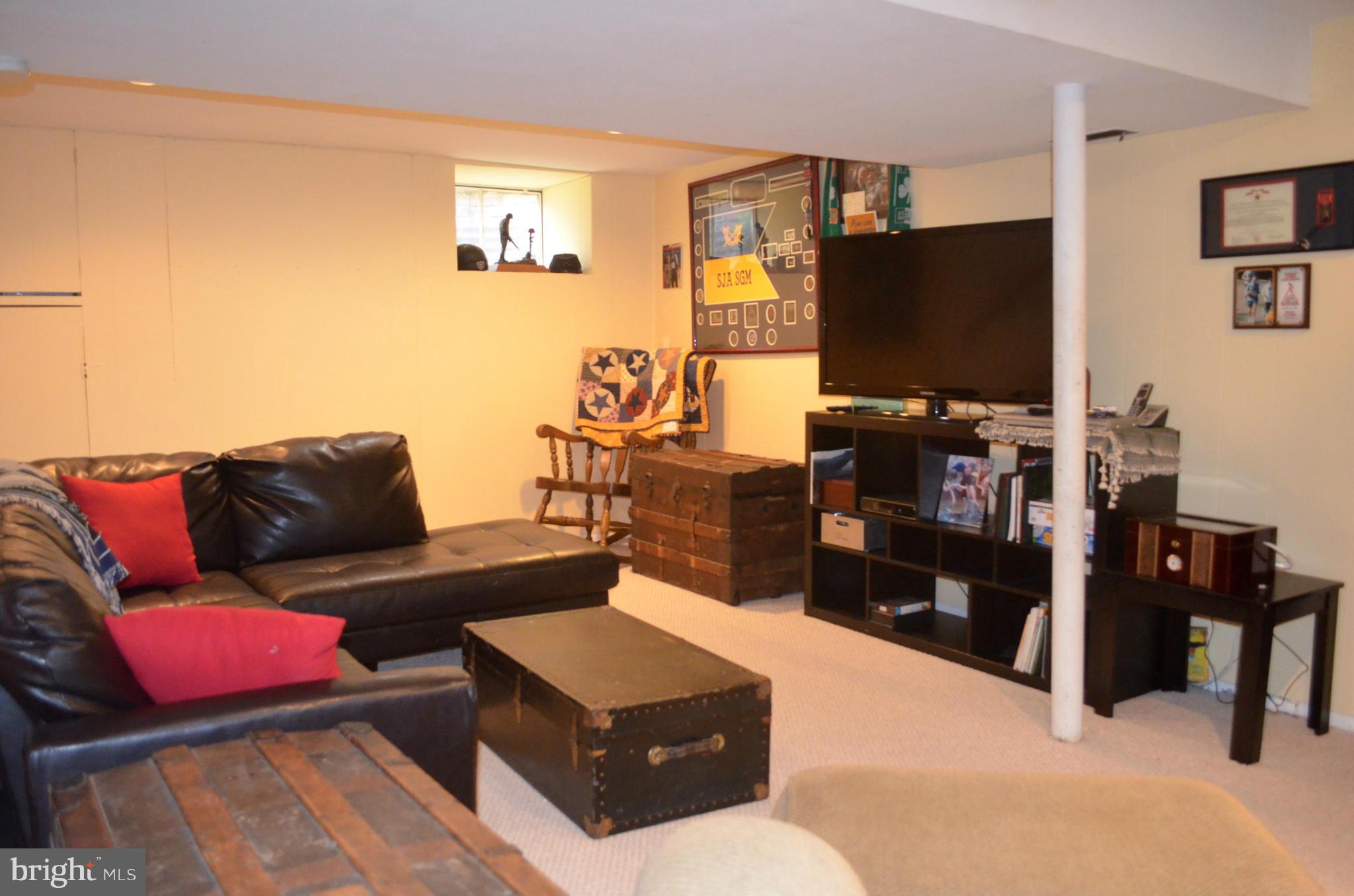 106 Indian Spring Drive Silver Spring, MD 20901 - Photo 30 of 30 a living room with furniture and a flat screen tv