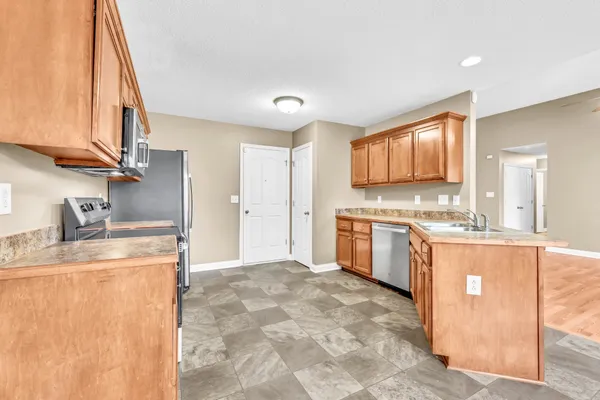 a kitchen with a stove a sink and a refrigerator