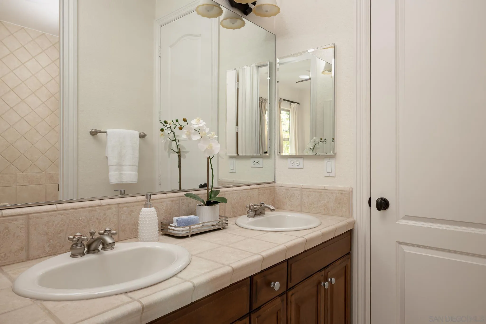 14014 Lake Poway Road Poway, CA 92064 - Photo 28 of 55 a bathroom with double vanity sinks and a mirror