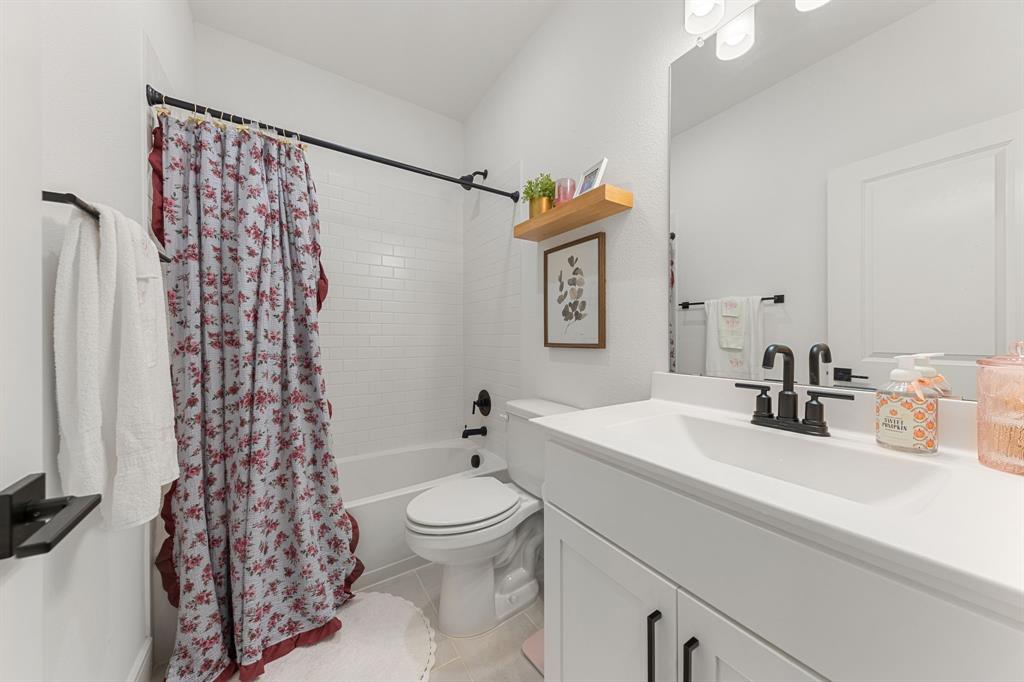 1340 Cartona Road Fate, TX 75087 - Photo 20 of 32 a bathroom with a sink toilet and shower