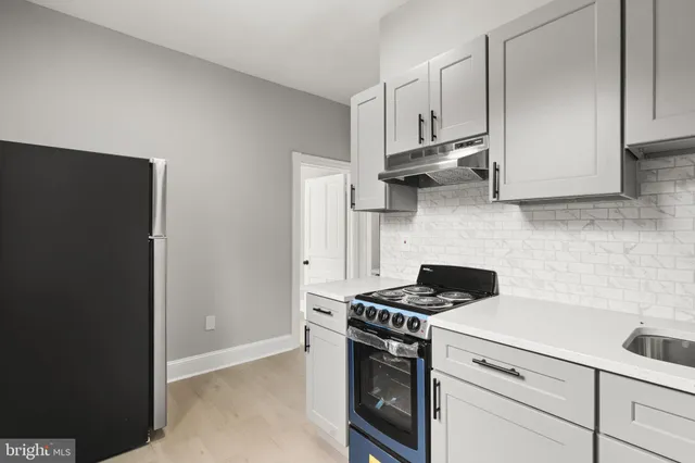 a kitchen with white cabinets and white appliances