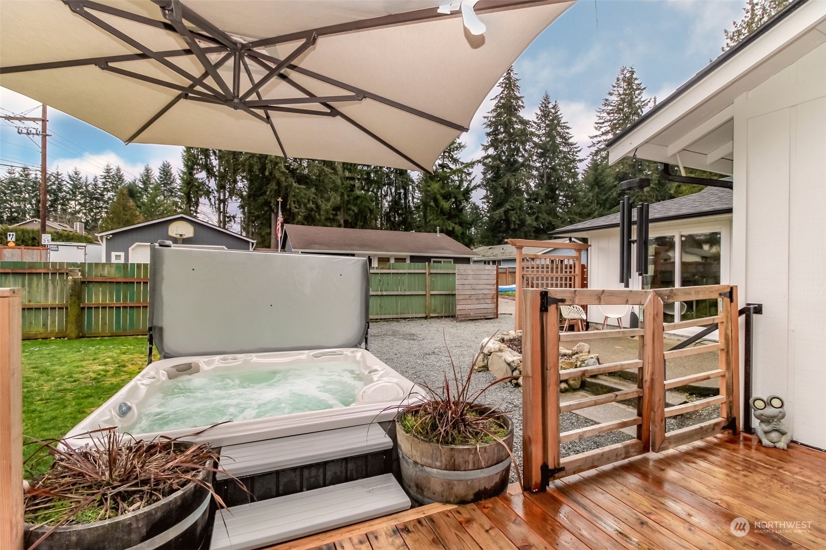 3017 Forest Rim Court South Puyallup, WA 98374 - Photo 33 of 40 a view of a patio with table and chairs under an umbrella