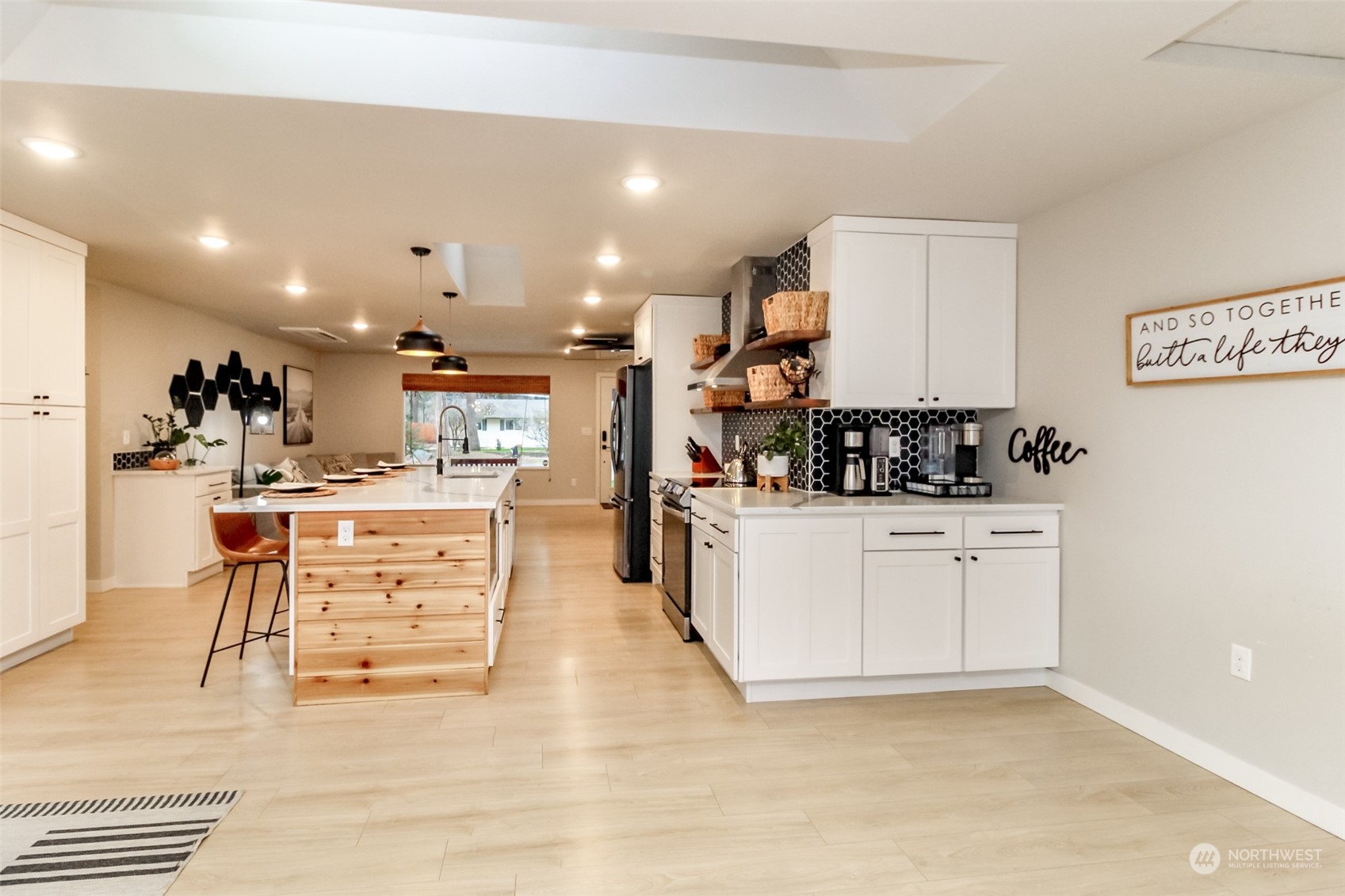 3017 Forest Rim Court South Puyallup, WA 98374 - Photo 9 of 40 a kitchen with stainless steel appliances kitchen island granite countertop a refrigerator and cabinets