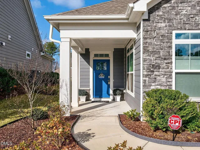 a view of a house with potted plants