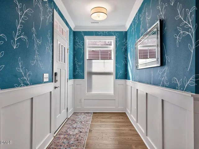 a view of a door and wooden floor