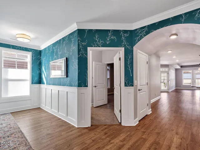 a view of a hallway with wooden floor and staircase