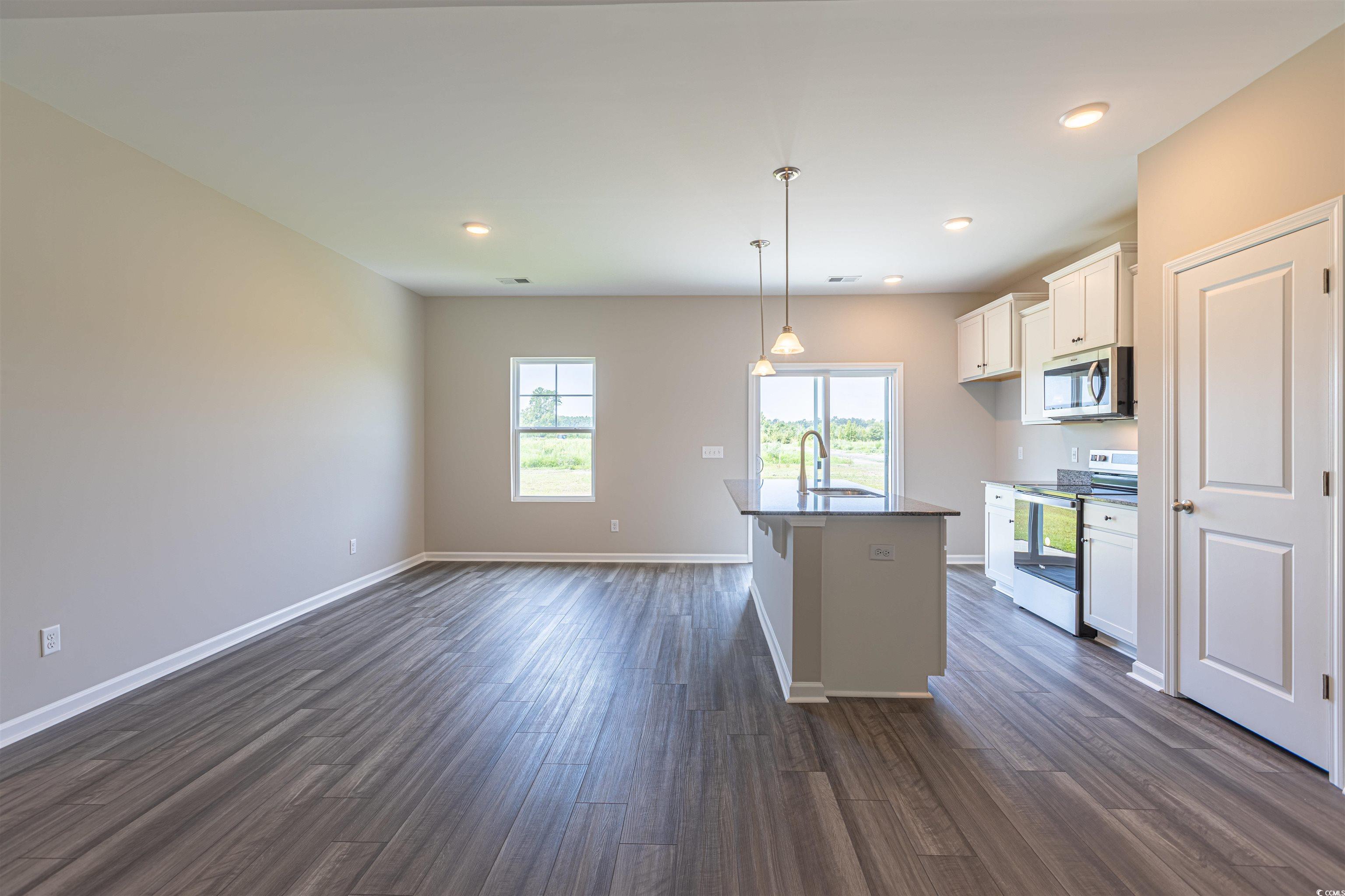 7064 Shady Grove Road Conway, SC 29527 - Photo 8 of 14 Kitchen featuring white cabinets, sink, a center i