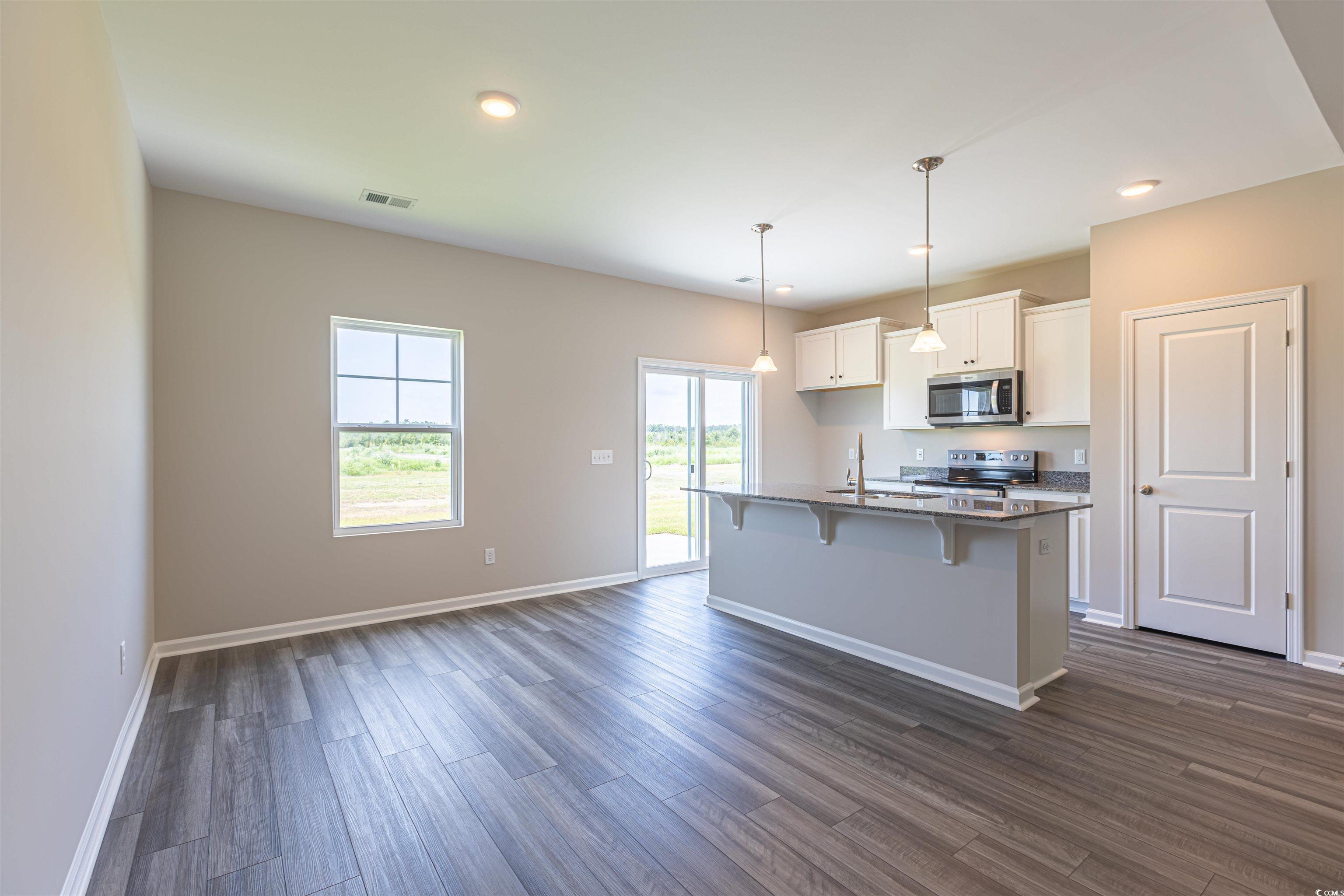 7064 Shady Grove Road Conway, SC 29527 - Photo 9 of 14 Kitchen with a kitchen island with sink, dark hard