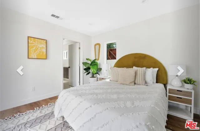 a bedroom with a large bed and a large window