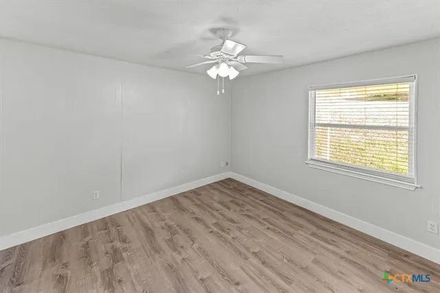 a view of a room with wooden floor and furniture