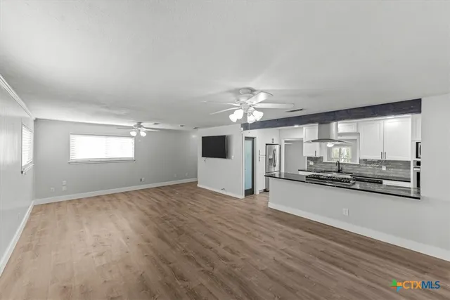 wooden floor in an empty room with a window