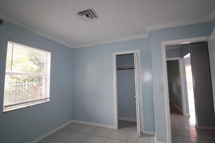 578 West 2nd Street Riviera Beach, FL 33404 - Photo 11 of 15 a view of an empty room with wooden floor and a window