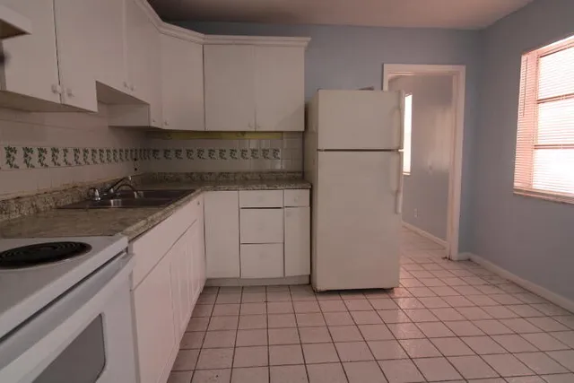 a kitchen with a sink and a refrigerator