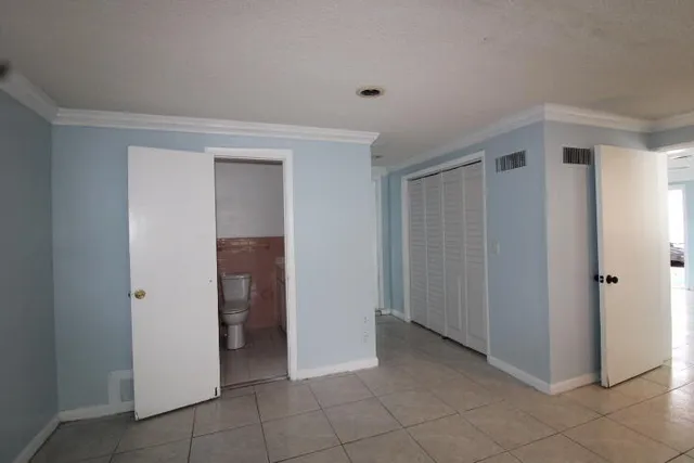 a view of an empty room and closet area
