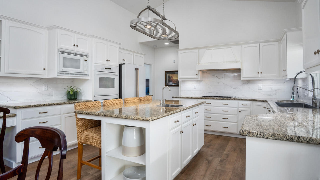 16657 Thomas Drive Springville, CA 93265 - Photo 14 of 37 a kitchen with stainless steel appliances granite countertop a sink stove and white cabinets