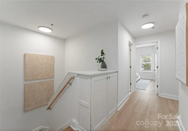 a view of hallway with wooden floor