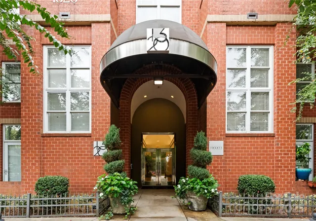a front view of a house with potted plants