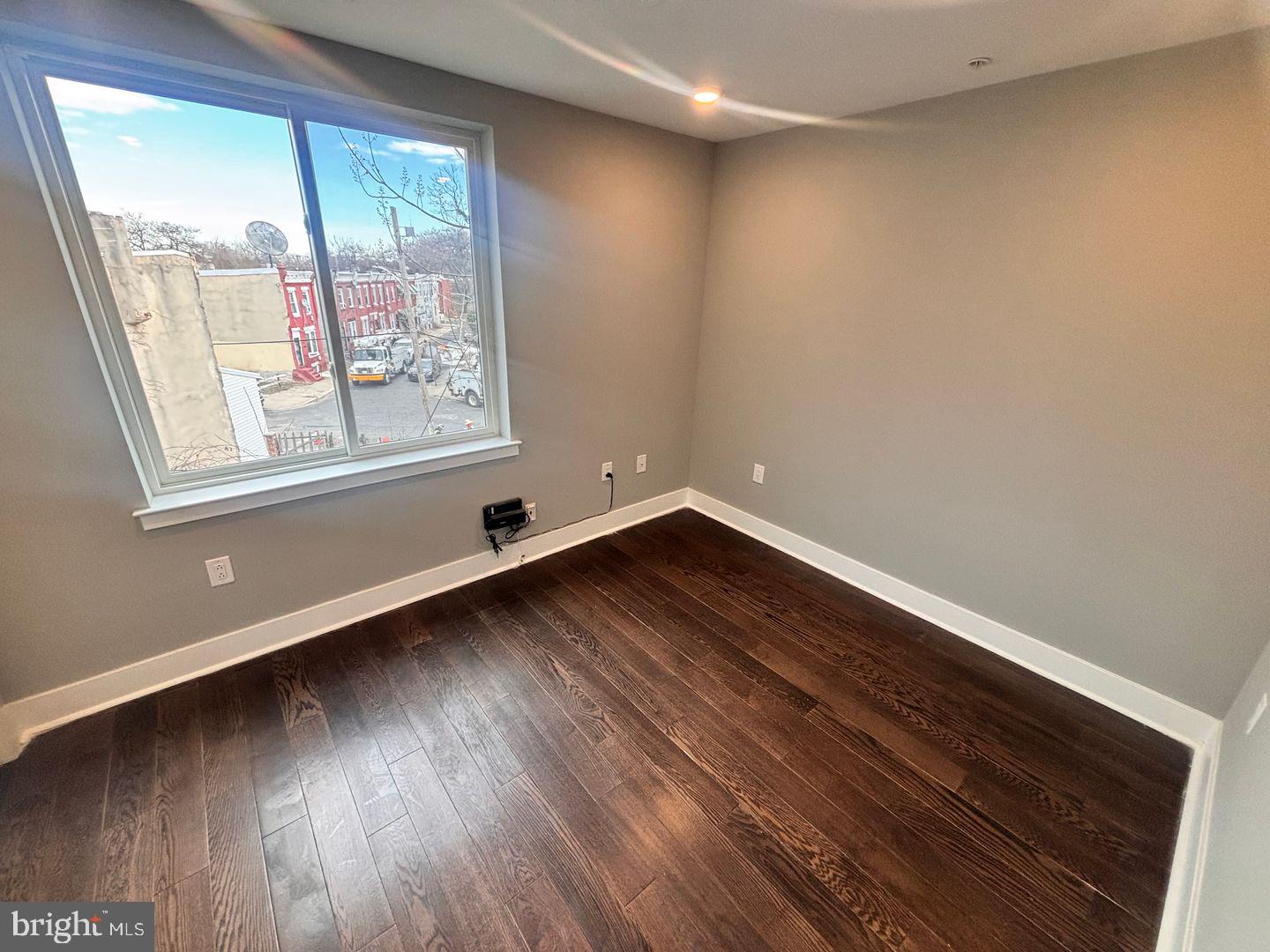 3255 Ridge Avenue Philadelphia, PA 19132 - Photo 11 of 28 an empty room with wooden floor and windows