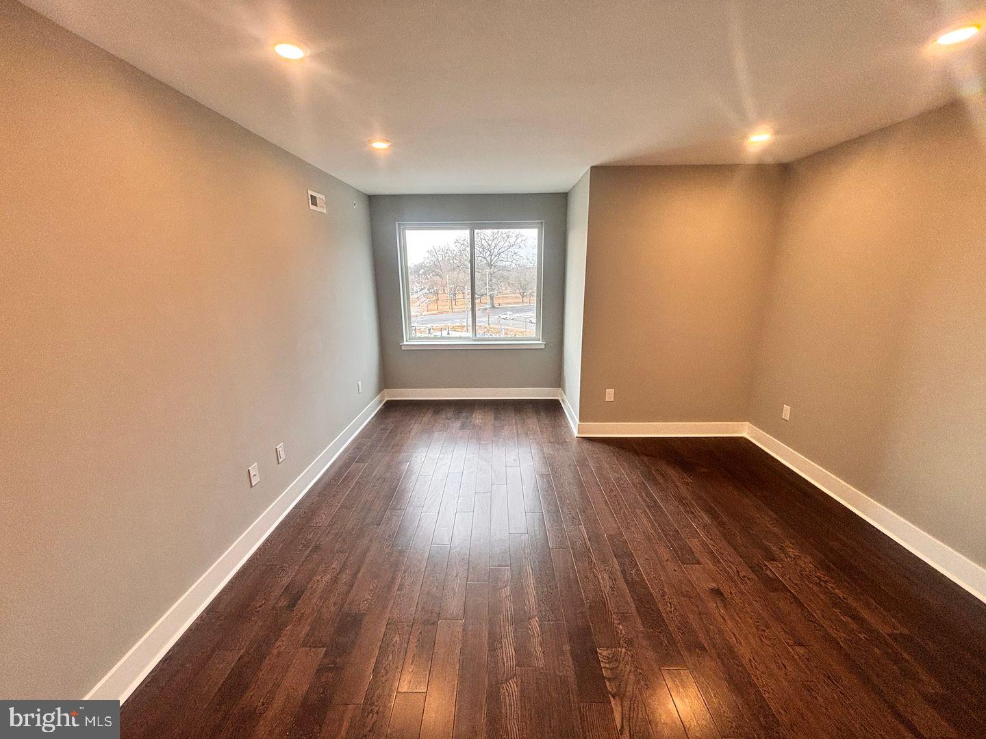 3255 Ridge Avenue Philadelphia, PA 19132 - Photo 18 of 28 a view of an empty room with wooden floor and a window