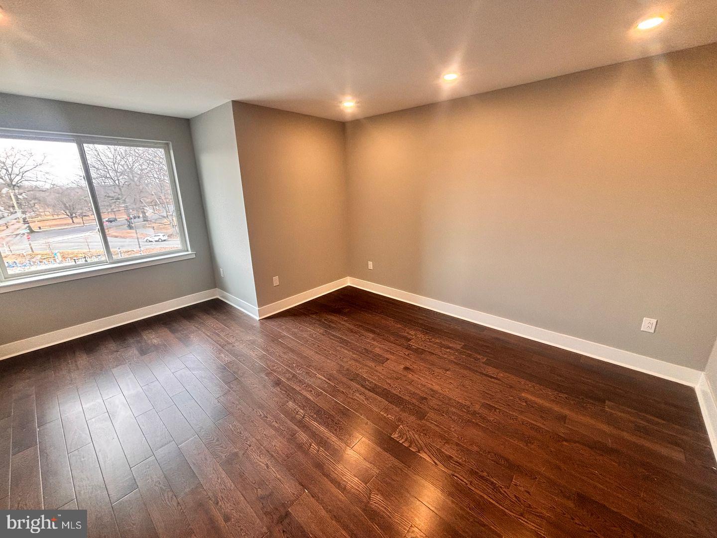3255 Ridge Avenue Philadelphia, PA 19132 - Photo 19 of 28 an empty room with wooden floor and windows